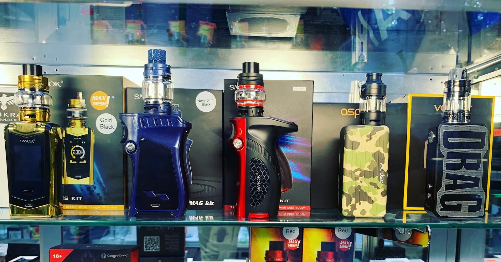 Box mods and tanks in the counter case at Six Fifty Smoke Shop.