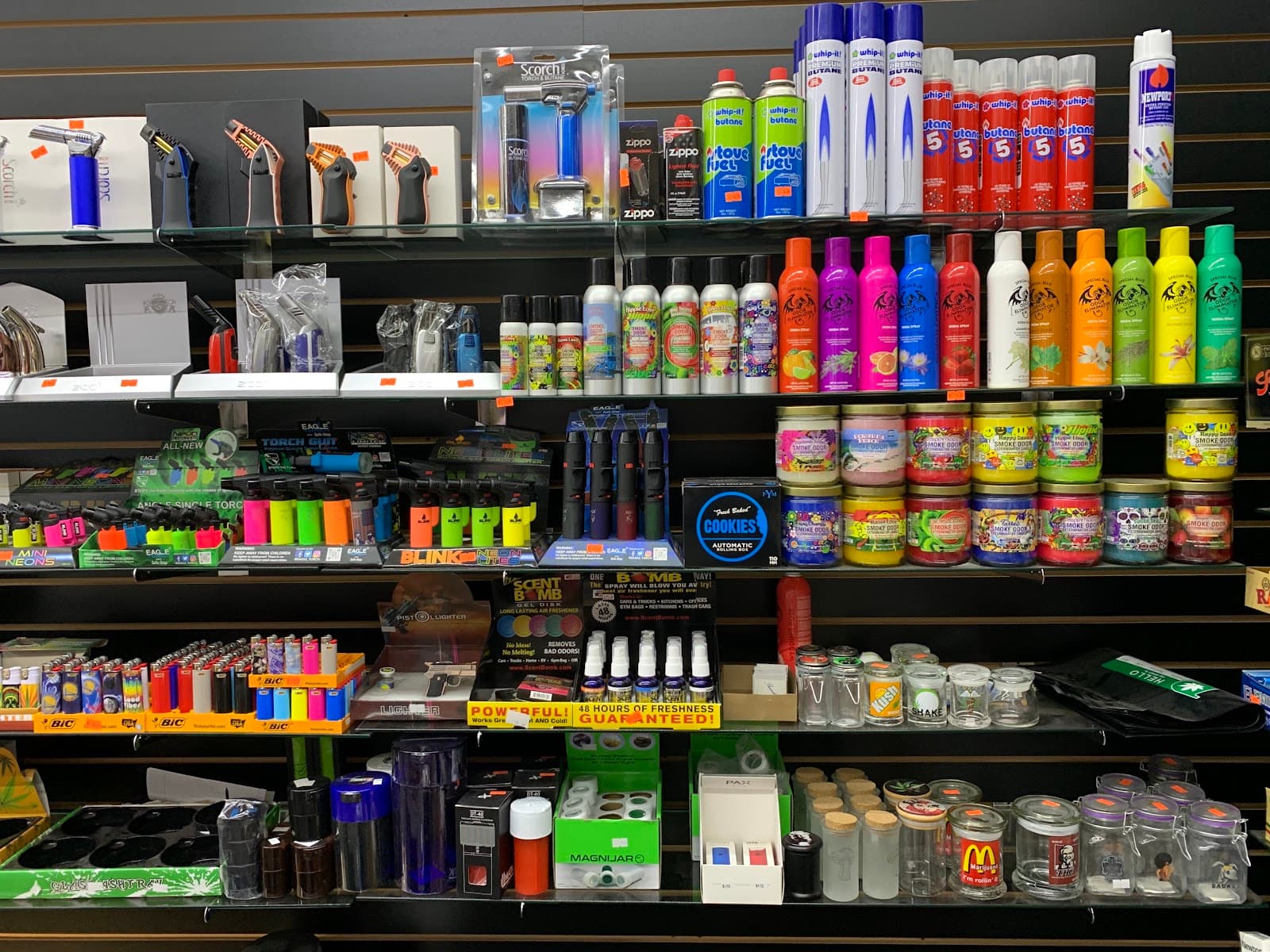 Torches, butane, grinders and jars on the accessory wall at Six Fifty Smoke Shop.