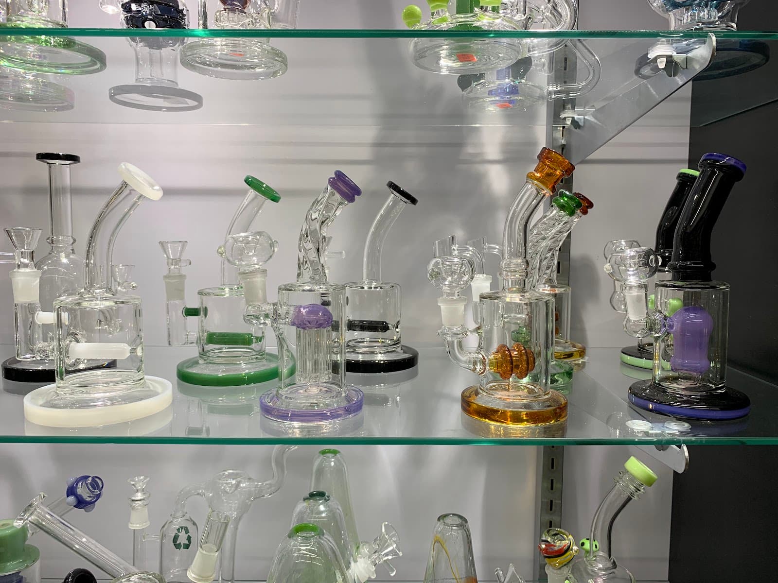Glass rigs and water pipes on the lit display shelves at Six Fifty Smoke Shop.