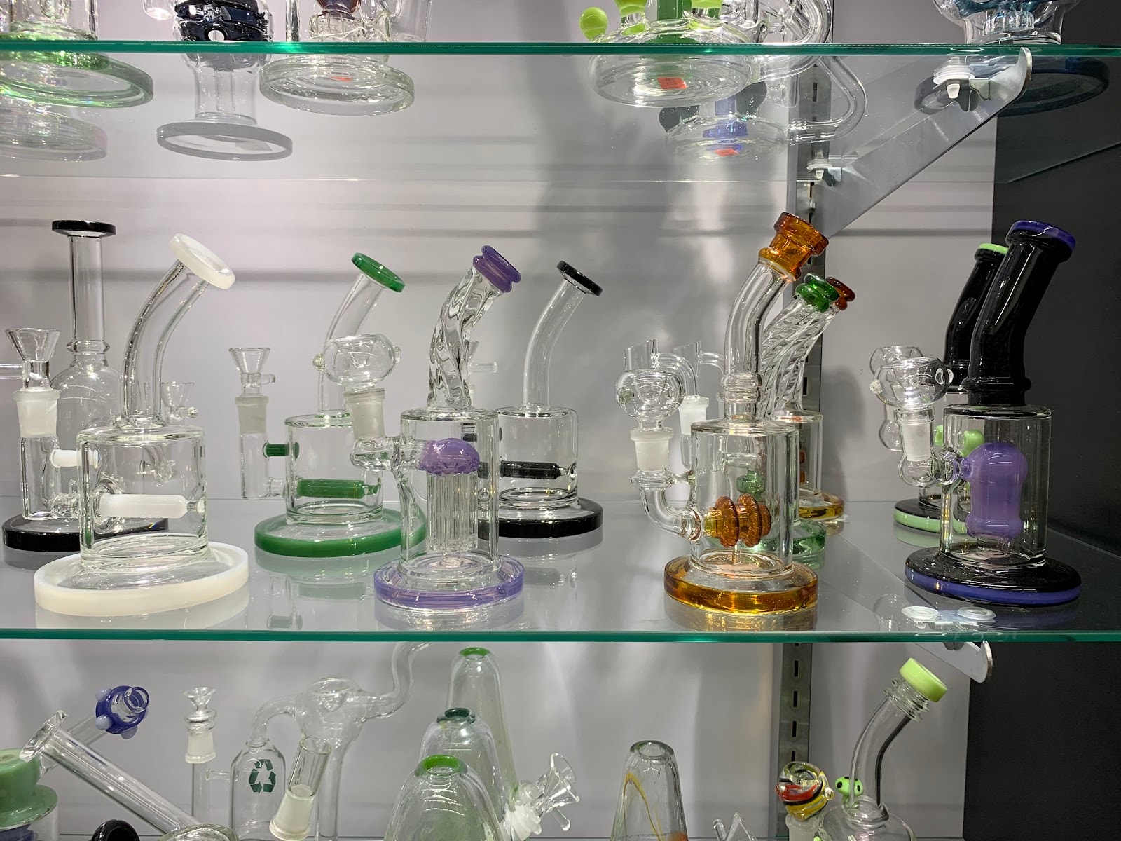 Glass rigs and water pipes on the lit display shelves at Six Fifty Smoke Shop.