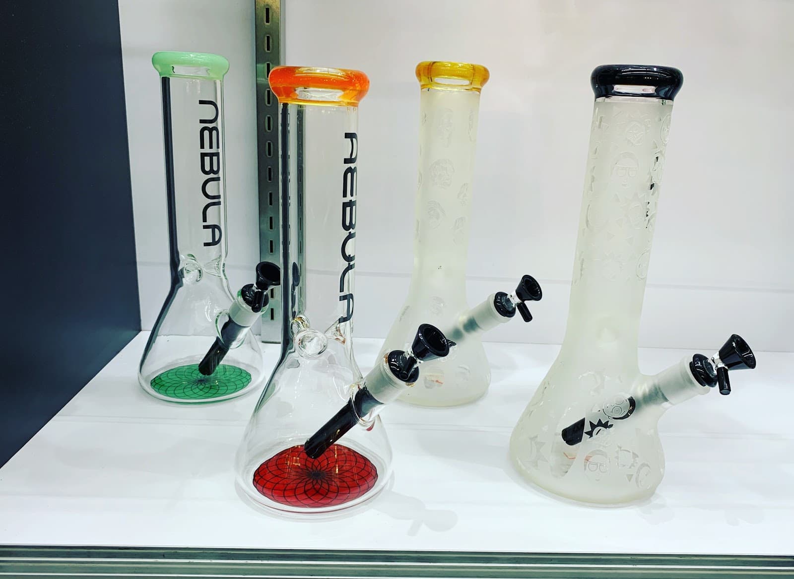 Frosted and clear beaker glass on the shelf at Six Fifty Smoke Shop.
