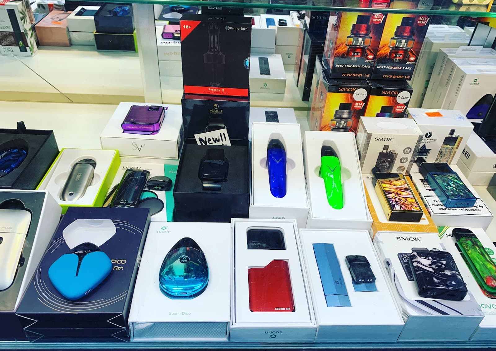 Pod systems and starter kits laid out in the display case at Six Fifty Smoke Shop.
