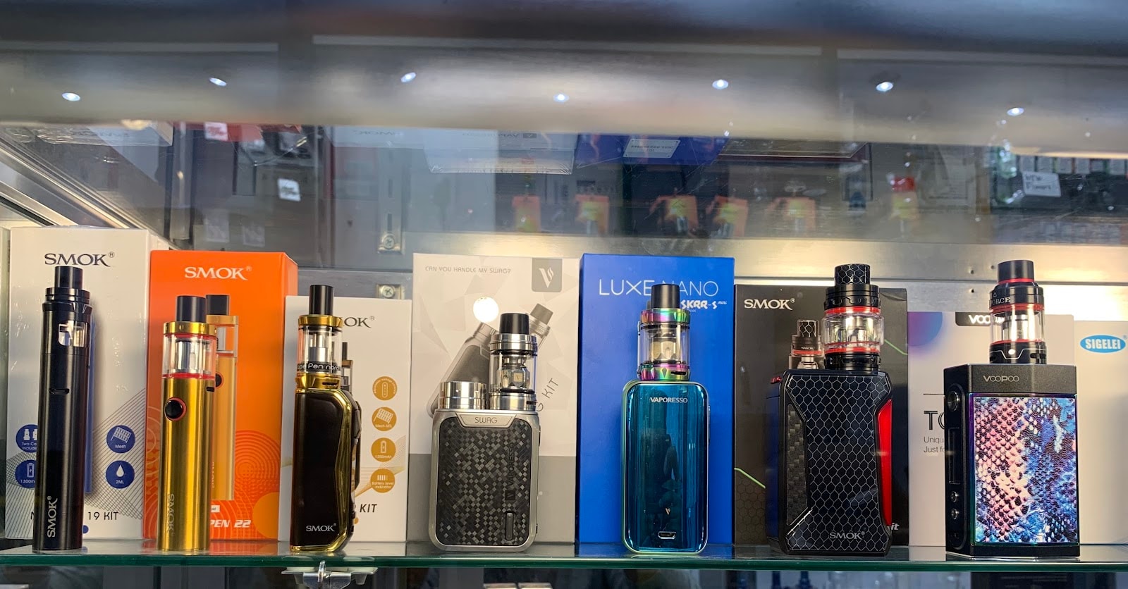 Vape kits and mods in the counter case at Six Fifty Smoke Shop.